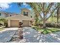 Inviting townhome with attached garages, mature landscaping, and a concrete driveway at 2915 Royal Tuscan Ln, Valrico, FL 33594