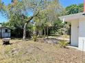 Spacious backyard features a shed, mature landscaping, and pergola at 312 N Manhattan Ave, Tampa, FL 33609