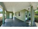View of covered carport area with exterior door and windows, providing extra covered space at 3216 W Paxton Ave, Tampa, FL 33611