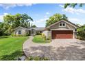 Charming home with a brick driveway, well-manicured lawn, and attached two-car garage at 3407 W Busch Blvd, Tampa, FL 33618