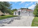 Attractive single-story home with a three-car garage, well-maintained lawn and concrete driveway at 3527 101St E Ave, Parrish, FL 34219