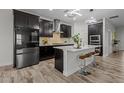 Modern kitchen boasts stainless steel appliances, dark cabinets, a center island with seating, and stylish pendant lighting at 4528 Ballantrae Blvd, Land O Lakes, FL 34638