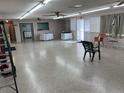 Large open hall with polished floors, table arrangements, and neutral decor ideal for gatherings and events at 5330 77Th N St, St Petersburg, FL 33709