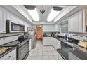 Bright kitchen features white cabinetry, granite countertops, and stainless steel appliances at 601 Cedar Grove Dr, Brandon, FL 33511