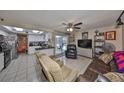 Open-concept living space featuring tile flooring, ample seating, and access to the outdoor patio at 601 Cedar Grove Dr, Brandon, FL 33511
