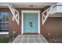 Close-up of a stylish light-blue double front door with decorative tile entryway at 613 Valley Hill Dr, Brandon, FL 33510