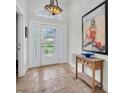 Inviting entryway with tiled floors, a decorative light fixture, and eye-catching wall art at 865 Live Oak Ne Ter, St Petersburg, FL 33703