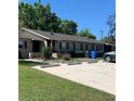 A row of well-maintained brick townhomes with a parking area in front of the units at 9501 Lake Park Dr # 9501, Thonotosassa, FL 33592