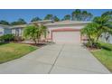 Home featuring a spacious two-car garage and a concrete driveway at 9823 Rolling Cir, San Antonio, FL 33576