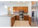 Kitchen with stainless steel appliances, granite countertops, and tile flooring at 9823 Rolling Cir, San Antonio, FL 33576