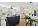 Open-concept living area featuring stylish furniture, a kitchen with counter seating, and bright, neutral decor at 9828 Lake Chase Island Way # 0, Tampa, FL 33626