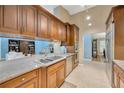 Well-equipped kitchen featuring wood cabinets, granite countertops, and stainless steel appliances at 1007 Morfield Ln, Brandon, FL 33511