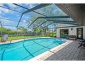 Screened-in pool area with chairs and floats, offering a relaxing outdoor experience at 1007 Morfield Ln, Brandon, FL 33511