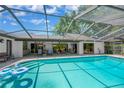 Inviting screened-in pool with patio furniture for outdoor dining and entertaining at 1007 Morfield Ln, Brandon, FL 33511
