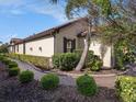 Beautifully landscaped yard with brick walkway showcasing lush green bushes around the house at 10450 Highland Park Pl, Palmetto, FL 34221