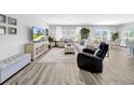 Open-concept living area with stylish furniture, large windows, and sleek flooring at 12908 Hawkstone Trail Blvd, Lithia, FL 33547