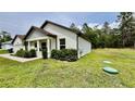 Exterior view of a single-Gathering home with a well-kept lawn and landscaped bushes at 13486 English Sparrow Rd, Weeki Wachee, FL 34614