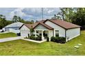 Well-maintained single-Gathering home with a lovely front yard and attached two-car garage at 13486 English Sparrow Rd, Weeki Wachee, FL 34614