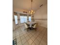 Cozy breakfast nook with tiled floors, bright chandelier and lots of natural light at 1695 Stable Trl, Palm Harbor, FL 34685
