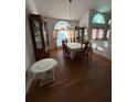 Formal dining room with elegant chandelier and large windows at 1695 Stable Trl, Palm Harbor, FL 34685