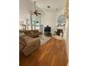 Open living room with high ceilings, hardwood floors, and cozy fireplace at 1695 Stable Trl, Palm Harbor, FL 34685