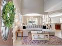 Bright living room with high ceilings, a large sectional, and view of the dining room at 17419 New Cross Cir, Lithia, FL 33547