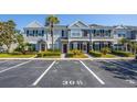 Well-maintained townhome exterior featuring neat landscaping, reserved parking, and classic architectural details at 309 Countryside Key Blvd, Oldsmar, FL 34677