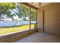 Enclosed patio overlooking a well maintained yard with a white fence at 309 Countryside Key Blvd, Oldsmar, FL 34677