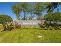 Beautiful community entrance with the 'Countryside Key' sign surrounded by lush landscaping at 309 Countryside Key Blvd, Oldsmar, FL 34677
