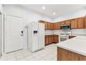 Bright kitchen with white appliances, light countertops, and wood cabinets at 31434 Shaker Cir, Wesley Chapel, FL 33543