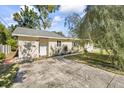 Single-story home with a concrete driveway and neatly landscaped yard at 3600 46Th N St, St Petersburg, FL 33713