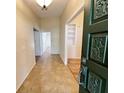 Inviting foyer with tile flooring, open doorway and view into other rooms of the home at 3907 Applegate Cir, Brandon, FL 33511