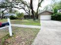 Home boasts a well-maintained lawn and mature trees at 3907 Applegate Cir, Brandon, FL 33511