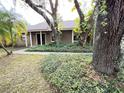 Front yard featuring beautiful, mature trees and walkway to front door at 3907 Applegate Cir, Brandon, FL 33511