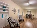 Bright living room featuring built-in shelves, stylish chairs, and a dining area with wood floors at 3907 Applegate Cir, Brandon, FL 33511