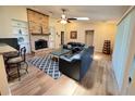Sunlit living room boasts a brick fireplace, wood floors, and a comfortable seating arrangement at 3907 Applegate Cir, Brandon, FL 33511