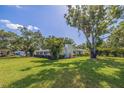 Beautifully landscaped property featuring a lush green lawn and mature trees surrounding the charming home at 4340 Narvarez S Way, St Petersburg, FL 33712