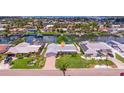 An aerial view showcases the home's well-kept lawn, driveway, landscaping, and waterfront location at 4433 38Th S Way, St Petersburg, FL 33711