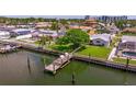 Aerial view of waterfront property with a private dock, pool and lush greenery at 4433 38Th S Way, St Petersburg, FL 33711