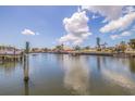Scenic waterfront view with boats docked, palm trees, and clear blue skies at 4433 38Th S Way, St Petersburg, FL 33711