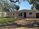 A single-story home with a charming front exterior and bright white-trimmed windows at 4716 W Vasconia St, Tampa, FL 33629