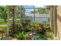 Enclosed garden area with a relaxing pond and waterfall feature, with lush plants and garden art at 4909 Linsey Ct # 0, Sarasota, FL 34243