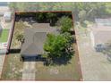 Aerial view highlighting the home's backyard, mature trees, fenced perimeter, and roofline at 5263 Kirkwood Ave, Spring Hill, FL 34608