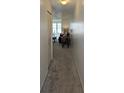 Hallway leading into a living room area with carpeted floors and a closet at 5623 80Th N St # 306, St Petersburg, FL 33709