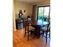 Cozy dining area with a round wooden table and seating for four, adjacent to sliding glass doors to a balcony at 6080 80Th N St # 409, St Petersburg, FL 33709