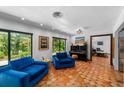 Bright living room featuring cozy seating, large windows and terra cotta tile floors at 6213 12Th S Ave, Gulfport, FL 33707
