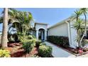 Beautiful landscaped front yard featuring lush greenery and a well-maintained walkway to the entrance at 6446 Louisiana Ave, New Port Richey, FL 34653