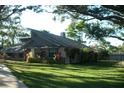 Well-maintained lawn surrounds a quaint home with architectural roof design at 7033 123Rd St, Seminole, FL 33772
