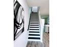Modern staircase with black and white accents, complemented by stylish black and white artwork at 8742 Turnstone Haven Pl, Tampa, FL 33619