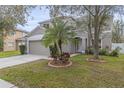 Charming two-story home boasts a well-manicured lawn and complemented by lush tropical landscaping and a two-car garage at 10525 Lucaya Dr, Tampa, FL 33647